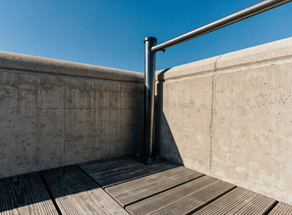 Hoekdetail waar een balustradepaal in de dakrand is verankerd
